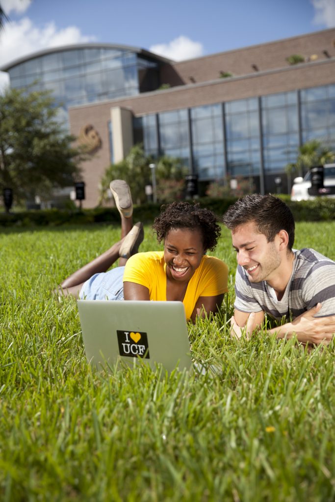 Two students in grass outside Career Services