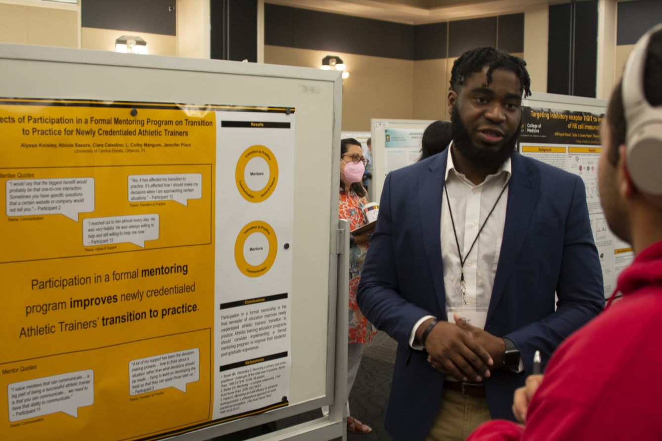 Student presenting a poster to a colleague