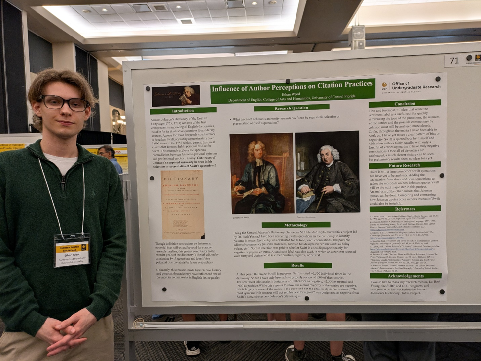 Ethan presenting a poster at the Summer Poster Showcase.