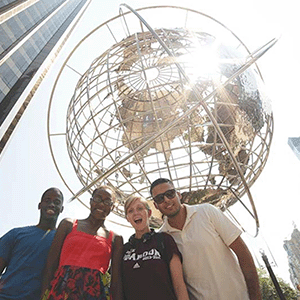 Students standing in front of globe