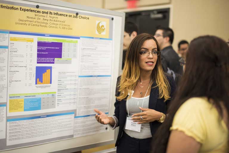 Student explaining at the Showcase of Undergraduate Research